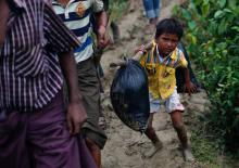 A Rohingya refugee boy carries his belongings as he walks to a makeshift camp in Cox's Bazar, Bangladesh, September 18, 2017. PHOTO BY REUTERS/Danish Siddiqui