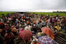 Rohingya refugees sit as they are temporarily held by the Border Guard Bangladesh (BGB) in an open area after crossing the border, in Teknaf, Bangladesh, September 3, 2017. PHOTO BY REUTERS/Mohammad Ponir Hossain