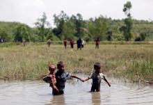 Rohingya children make their way through water as they try to come to the Bangladesh side from No Man’s Land after a gunshot being heard on the Myanmar side, in Cox’s Bazar, Bangladesh. PHOTO BY REUTERS/Mohammad Ponir Hossain