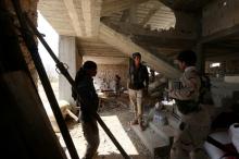 Fighters of the Syria Democratic Forces (SDF) stand inside a building near Manbij, in Aleppo Governorate, Syria, June 17, 2016. PHOTO BY REUTERS/Rodi Said