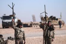 Syrian Democratic Forces (SDF) fighters hold up their weapons in the north of Raqqa city, Syria, February 3, 2017. PHOTO BY REUTERS/Rodi Said