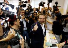 Lebanese prime minister and candidate for the parliamentary election Saad al-Hariri shows his ink-stained finger after casting his vote during the parliamentary election in Beirut, Lebanon, May 6, 2018. PHOTO BY REUTERS/Jamal Saidi