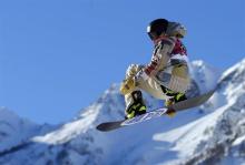 Sage Kotsenburg of the U.S. performs a jump during the men's snowboard slopestyle semi-final competition at the 2014 Sochi Olympic Games in Rosa Khutor