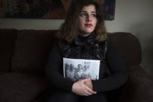Recent refugee from Syria Sandy Khabbazeh poses for a portrait while holding a photo of her family who remain behind in Syria, in Oakland, New Jersey, November 22, 2015. PHOTO BY REUTERS/Carlo Allegri