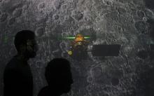 Student walk past a screen during a live streaming of Chandrayaan-2 landing at an educational institute in Mumbai, India, September 7, 2019. PHOTO BY REUTERS/Francis Mascarenhas