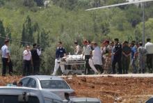 A security member, who was injured during an attack at a camp for Syrian refugees in eastern Jordan near the borders of Iraq, Syria and Jordan, is transported from a military helicopter to al-Hussein Medical Centre in Amman, Jordan, June 21, 2016. PHOTO BY REUTERS/Stringer