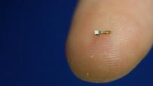 A dust-sized wireless sensor that makes it possible to wirelessly monitor neural activity in real time when implanted inside the body, is shown on a finger. PHOTO BY REUTERS/UC Berkeley