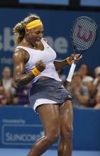 Serena Williams of the U.S. reacts as she defeats Maria Sharapova of Russia during their women's singles semi-final match at the Brisbane International tennis tournament in Brisbane