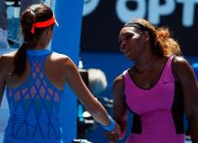 Ana Ivanovic (L) of Serbia shakes hands with Serena Williams of the U.S. after winning their women's singles match at the Australian Open 2014 tennis tournament in Melbourne