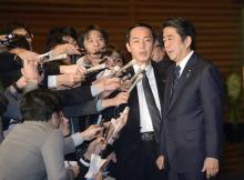 Japan's Prime Minister Shinzo Abe (R) speaks to the media at his official residence in Tokyo, January 25, 2015. PHOTO BY REUTERS/Kyodo