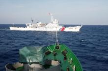 A ship (top) of the Chinese Coast Guard is seen near a ship of the Vietnam Marine Guard in the South China Sea, about 210 km (130 miles) off shore of Vietnam, May 14, 2014. PHOTO BY REUTERS/Nguyen Minh