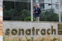 An employee stands near the headquarter building of the state energy company Sonatrach in Algiers, Algeria, June 26, 2016. PHOTO BY REUTERS/Ramzi Boudia