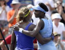 Venus Williams (USA) (right) hugs Serena Williams (USA) (left) after winning their match on day six of the Rogers Cup tennis tournament at Uniprix Stadium, Montreal, Quebec, Canada