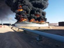 Smoke and flame rise from an oil storage tank that was set on fire amid fighting between rival factions at Ras Lanuf terminal, Libya in this handout picture released on June 18, 2018. PHOTO BY REUTERS/The National Oil Corporation
