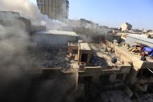 Smoke rises from the site of a bomb attack near Khullani Square in Baghdad