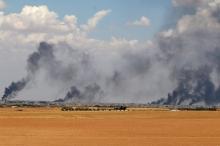 Smoke rises from Manbij city, Aleppo province, Syria June 8, 2016. PHOTO BY REUTERS/Rodi Said