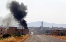 Smoke rises from Taybat al Imam town after rebel fighters from the hardline jihadist Jund al-Aqsa advanced in the town in Hama province, Syria, August 31, 2016. PHOTO BY REUTERS/Ammar Abdullah
