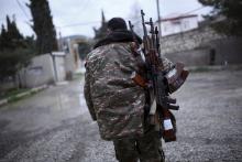 A soldier of the self-defense army of Nagorno-Karabakh carries weapons in Martakert province, which according to Armenian media was affected by clashes over the breakaway Nagorno-Karabakh region, April 4, 2016. PHOTO BY REUTERS/Vahan Stepanyan