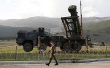 Soldiers of the German armed forces Bundeswehr stand next to the Patriot system before the arrival of Germany's Chancellor Angela Merkel at a Turkish military base in Kahramanmaras, February 24, 2013. PHOTO BY REUTERS/Murad Sezer