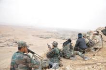Forces loyal to Syria's President Bashar al-Assad take positions on a look-out point overlooking the historic city of Palmyra in Homs Governorate in this handout picture provided by SANA, March 27, 2016. PHOTO BY REUTERS/SANA