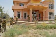 Iraqi security forces personnel walk with their weapons as they inspect a house south of Falluja, Iraq, June 6, 2016. PHOTO BY REUTERS/Stringer