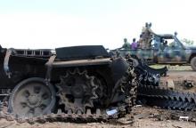 Sudan People’s Liberation Movement (SPLM) soldiers drive past military tanks that were destroyed and abandoned in the recent fighting in the Jabel area of Juba, South Sudan, July 16, 2016. REUTERS/Stringer