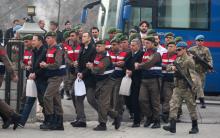 Turkish soldiers accused of attempting to assassinate President Tayyip Erdogan on the night of the failed last year's July 15 coup, are escorted by gendarmes as they arrive for the first hearing of the trial in Mugla, Turkey, February 20, 2017. PHOTO BY REUTERS/Kenan Gurbuz