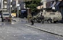Israeli soldiers and border policemen take position during clashes with Palestinians in the West Bank city of Hebron