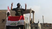 A member of the Iraqi security forces gestures at a government complex in the city of Ramadi, December 28, 2015. PHOTO BY REUTERS/Stringer