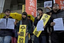 Hong Kong student leaders (L-R) Oscar Lai, Agnes Chow, Joshua Wong and Derek Lam speak as they arrive at the police headquarters in Hong Kong, January 16, 2015. PHOTO BY REUTERS/Tyrone Siu