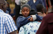 A student embraces her parent following a fire which burnt down one dormitory of Moi Girls school in Nairobi, Kenya, September 2, 2017. PHOTO BY REUTERS/Baz Ratner