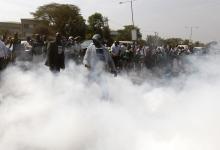 Students from Langata primary school and activists run from teargas fired by riot police during a protest against a perimeter wall erected by a private developer around their school playground in Kenya's capital Nairobi, January 19, 2015. PHOTO BY REUTERS/Thomas Mukoya