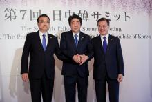 Chinese Premier Li Keqiang, Japanese Prime Minister Shinzo Abe and South Korean President Moon Jae-in pose for photographers prior to their summit in Tokyo, Wednesday, May 9, 2018. PHOTO BY REUTERS/Eugene Hoshiko