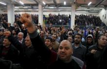 Supporters of Lebanon's Hezbollah leader Sayyed Hassan Nasrallah gesture while they are listening to his speech via a screen during a commemoration service marking one week since the killing of Hezbollah militant leader Samir Qantar, in Beirut's southern suburbs, December 27, 2015. PHOTO BY REUTERS/Aziz Taher