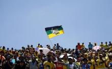 Supporters of the African National Congress (ANC) wave a party flag during the party's 104th anniversary celebrations in Rustenburg, South Africa, January 9, 2016. PHOTO BY REUTERS/Siphiwe Sibeko