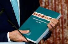 U.S. Secretary of State John Kerry holds a copy of the 2016 Trafficking in Persons (TIP) report during the TIP Heroes Ceremony at the State Department in Washington, June 30, 2016. PHOTO BY REUTERS/Kevin Lamarque
