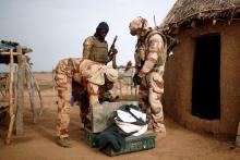 Troops from the Malian Armed Forces (FAMa) and a French soldier conduct a joint patrol in Ndaki, Mali, July 29, 2019. PHOTO BY REUTERS/Benoit Tessier