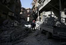 A man walks on the rubble of damaged buildings at the besieged town of Douma, Eastern Ghouta, Damascus, Syria, March 5, 2018. PHOTO BY REUTERS/Bassam Khabieh