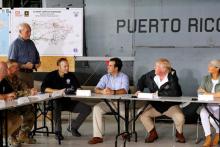 U.S. President Donald Trump addresses White House Chief of Staff John Kelly (L) before a briefing on hurricane relief efforts in a hangar at Muniz Air National Guard Base in Carolina, Puerto Rico, U.S. October 3, 2017. PHOTO BY REUTERS/Jonathan Ernst