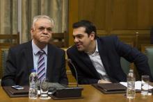 Greek Prime Minister Alexis Tsipras (R) talks to Deputy Prime Minister Yannis Dragasakis during the first meeting of new cabinet post elections in the parliament building in Athens, January 28, 2015. PHOTO BY REUTERS/Marko Djurica