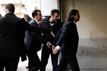 Two of the eight Turkish soldiers, who fled to Greece in a helicopter and requested political asylum after a failed military coup against the government, are escorted by police officers as they arrive at the appeals court in Athens, Greece, March 16, 2018. PHOTO BY REUTERS/Costas Baltas