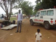 A U.N. ambulance drives past a displaced South Sudanese man in a camp for internally displaced people in the United Nations Mission in South Sudan (UNMISS) compound in Tomping, Juba, South Sudan, July 12, 2016. PHOTO BY REUTERS/Beatrice Mategwa/United Nations Mission in South Sudan (UNMISS)