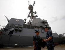 U.S. Navy's Pacific Fleet Commander Admiral Harry Harris (L) speaks to an officer outside USS Spruance, an Arleigh Burke-class guided missile destroyer, moored in Singapore, January 22, 2014. PHOTO BY REUTERS/Edgar Su