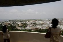 Visitors look out over U.S. Marine Corps Air Station Futenma in Ginowan on Okinawa May 3, 2010. PHOTO BY REUTERS/Issei Kato