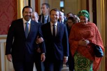 French President Emmanuel Macron walks between Lebanon's Prime Minister Saad al-Hariri and UN Deputy Secretary General Amina Mohammed as they arrive to attend the Lebanon International Support Group meeting in Paris, France, Decdember 8, 2017. PHOTO BY REUTERS/Philippe Wojazer