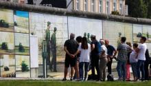 Visitors look at the art installation "Beyond The Wall" by German artist Stefan Roloff at the backside of the East Side Gallery in Berlin, Germany, August 10, 2017. PHOTO BY REUTERS/Hannibal Hanschke