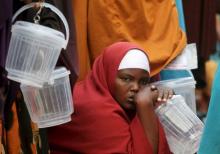 Somali families wait in a queue to receive iftar (breaking of fast) meal from a Qatari charity organization during the holy Muslim month of Ramadan in capital Mogadishu, June 22, 2015. PHOTO BY REUTERS/Feisal Omar
