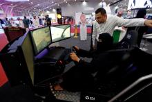 A Saudi woman tries a car simulator during women car show in Riyadh, Saudi Arabia, May 13, 2018. PHOTO BY REUTERS/Faisal Al Nasser