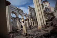 A woman prays among the rubble of the damaged main cathedral in downtown Port-au-Prince, January 9, 2011. PHOTO BY REUTERS/Allison Shelley