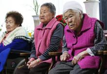 Former South Korean "comfort women" watch a news report as they wait for the result of meeting between foreign ministers of South Korea and Japan at the "House of Sharing," a special shelter for former "comfort women", in Gwangju, South Korea, December 28, 2015. PHOTO BY REUTERS/Hong Ki-won
